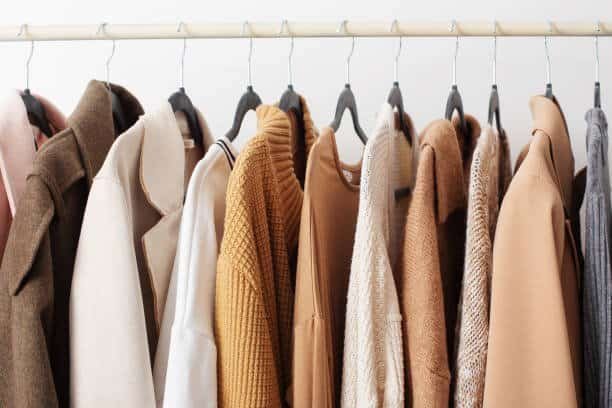 A rack of clothes with different colors.